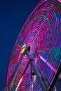 Blurred purple lights at night on ferris wheel at carnival county fair Royalty Free Stock Photo