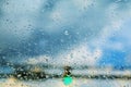 Blurred rain drops on car glass focus on the road way and safe drive in bad weather during rain storm on the of focus view Royalty Free Stock Photo