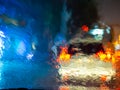 Blurred rain drops on car window with road light bokeh on rainy season abstract background Royalty Free Stock Photo