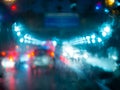 Blurred rain drops on car window with road light bokeh on rainy season abstract background Royalty Free Stock Photo
