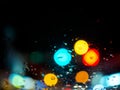 Blurred rain drops texture on car window with colorful bokeh abstract background on the road Royalty Free Stock Photo