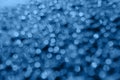 Blurred raindrops on the glass Classic blue color