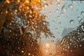 Blurred raindrops with street light bokeh on car wind shield