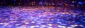 blurred rays of light on disco floor. orange violet blue neon searchlight lights. laser lines and lighting effect