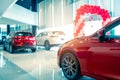 Blurred rear view of red and white luxury SUV car parked in modern showroom for sale. SUV car with sports design in showroom. Car Royalty Free Stock Photo