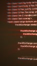 Blurred red-blue distorted code lines displayed on a dark screen, creating a glitchy digital programming aesthetic Royalty Free Stock Photo