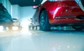 Blurred red and white car parked in modern showroom. Car dealership and auto leasing concept. Automotive industry. Modern luxury Royalty Free Stock Photo