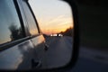 Blurred road and sunset in car rearview mirror Royalty Free Stock Photo