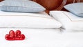 Blurred Romantic interior for Valentine's day with bed. Two red hearts on white. Royalty Free Stock Photo