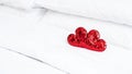 Blurred Romantic interior for Valentine's day with bed. Two red hearts on white. Royalty Free Stock Photo