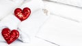 Blurred Romantic interior for Valentine's day with bed. Two red hearts on white. Royalty Free Stock Photo