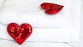 Blurred Romantic interior for Valentine's day with bed. Two red hearts on white. Royalty Free Stock Photo