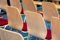 Blurred rows of empty wooden chairs in a large assembly hall.Empty chairs in conference hall.Interior meeting room. Royalty Free Stock Photo