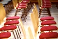 Blurred rows of empty wooden chairs in a large assembly hall.Empty chairs in conference hall.Interior meeting room. Royalty Free Stock Photo