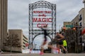 Blurred Runner in Pink Shoes Runs Past Magic City Sign