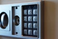 Blurred safe with combination lock in a hotel room, closeup numbers with tilt shift effect. Selective focus