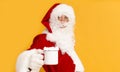 Blurred Santa Claus drinking hot cocoa with marshmallows