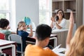 blurred schoolgirl raising hand near african Royalty Free Stock Photo