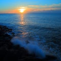 Blurred sea wave crashing over rocks Royalty Free Stock Photo