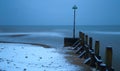 Blurred sea waves on a snowy beach