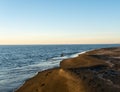 Blurred seaside background, blue sea and black sand beach, scenery background with sky gradient, selective focus Royalty Free Stock Photo