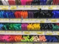 Blurred several color pens stack row in stationary shop store background.