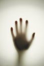 Blurred shadow of hand behind glass, concept of nightmare, crazy people Royalty Free Stock Photo
