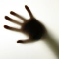 Blurred shadow of hand behind glass, concept of nightmare, crazy people Royalty Free Stock Photo