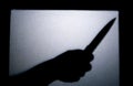 Blurred shadow of hand holding big sharp knife,Halloween theme Royalty Free Stock Photo