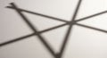 Blurred shadows on a light surface intersect to create angular shapes, forming a Royalty Free Stock Photo