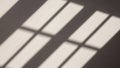 Blurred shadows of a window grid are cast on a surface creating a series of Royalty Free Stock Photo