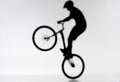 blurred shot of silhouette of trial biker performing bunny hop