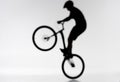 blurred shot of silhouette of trial biker performing bunny hop Royalty Free Stock Photo