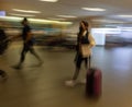 Blurred shot of travelers inside the busy international airport of Lima, Peru
