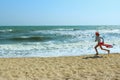 Blurred Shot Of A Young Girl Running On The Beach. People, Childhood, Travel Concept.