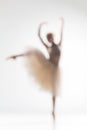 Blurred silhouette of ballerina on white background