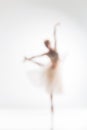 Blurred silhouette of ballerina on white background