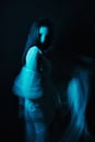 Blurred silhouette of a Ghost girl in a dress on a dark background