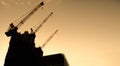 Silhouette Hoisting cranes machine for move materials at building construction site Royalty Free Stock Photo