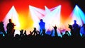 blurred silhouettes of rock band musicians on stage and crowd at a concert