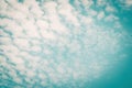 Blurred sky background with natural scattered clouds on wind movement on paper texture Royalty Free Stock Photo