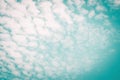 Blurred sky background with natural scattered clouds on wind movement on paper texture Royalty Free Stock Photo