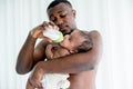 African father feeding milk from bottle milk to his baby newborn daughter Royalty Free Stock Photo