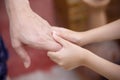 Blurred soft focus asian child girl hand holding father for familly bonding love background close up