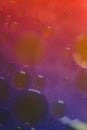 Blurred soft focus of oil spheres in water with color transition from red to blue tones for colorful background Royalty Free Stock Photo