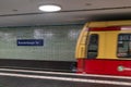 A blurred subway train enters the Brandenburg Gate station in Berlin