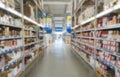 Blurred supermarket aisle with colorful shelves of merchandise. Perspective view