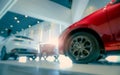 Blurred SUV car parked in modern showroom. Car dealership and auto leasing concept. Automotive industry. Modern luxury showroom. Royalty Free Stock Photo