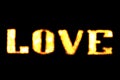 LOVE sign blurred text LED Bokeh light yellow gold on dark wall, Neon Light led letter Love on background black Royalty Free Stock Photo