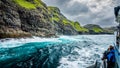 Blurred tourists observe the spectacular Vestmanna cliffs in Faroe Islands Royalty Free Stock Photo